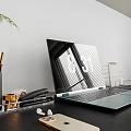 Modern Laptop On Office Desk With Phone Headphones Stationery And Plant Leaves