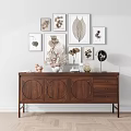 Wooden Console Table With Circular Panels Drawers Decorative Vases Dried Plants And Botanical Wall Art