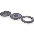 Three Black Circular Mechanical Components With Central Holes And Raised Edges