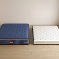 Blue And White Mattresses With Diamond Patterns On Wooden Floor In Simple Room