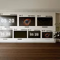 Multiple Samsung Televisions with Time Display and Black Hole Image on Wall