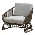 Stylish Wicker Armchair with Light Gray Cushion and Modern Frame Design