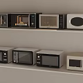 Various Microwave Ovens Arranged On Shelves With Different Designs
