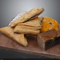 Freshly Baked Flaky Pastries and Assorted Bread Loaves on Wooden Board