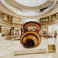 Giant Spiral Art Installation In Shopping Mall Atrium With Marble Base And Luxury Stores