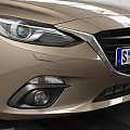 Golden Tan Sedan Car With Modern Sleek Exterior And Alloy Wheels In Indoor Showroom