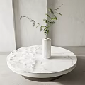 Round White Marble Coffee Table with White Vase and Green Plant in Modern Minimalist Interior