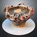 Intricate Ceramic Sculpture With Hollow Holes And Curved Textures On White Base