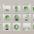 Decorative Green Ornament Set With Carved Circular Designs In White Display Cases On Black Bases
