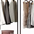 Stylish Hanging Clothes With Plaid Coats Layered Dresses Lace Details And Brown Suitcase