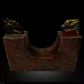 Decorative Red And Gold U Shaped Artifact With Animal Head Ornaments And Geometric Patterns