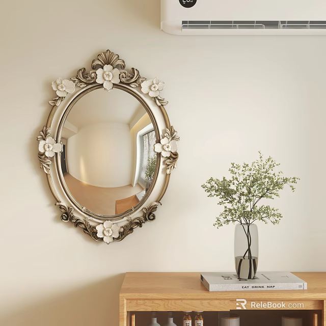 Ornate Oval Mirror with Floral Decorations Hanging on Light Wall Beside Green Plant Vase 3d model 