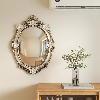 Ornate Oval Mirror with Floral Decorations Hanging on Light Wall Beside Green Plant Vase 3d model