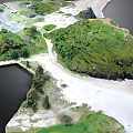 Lush Garden Landscape With Green Hills Trees Winding Paths Rocks And Sandy Shores