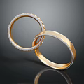 Elegant Gold Rings With Diamond Encrusted Edges And Intertwined Design