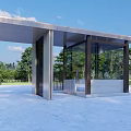 Modern Guardhouse Structure With Glass Walls And Metal Roof In Open Green Area