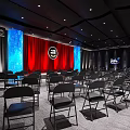 Contemporary Event Venue Stage With Red Curtains Blue Starry Backdrop And Black Chairs