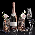 Elegant Pink Champagne Bottle And Crystal Wine Glasses With Ice Cubes Roses And Blackberries