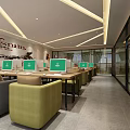Modern Internet Cafe Interior With Multiple Computers Comfortable Seats And Bright Lighting