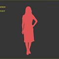 Woman in Green Dress With White Floral Patterns And Lace Hem Standing Against Gray Background