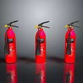 Three Red Fire Extinguishers with Yellow Nozzles on Black Reflective Surface