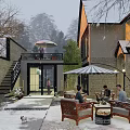 Snowy Courtyard Garden With Outdoor Furniture Umbrella And People Enjoying Winter Scene
