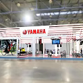 YAMAHA Exhibition Booth With White Red Striped Design And Displayed Motorcycles Screens