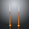 Two Orange Candles With White Wicks And Bases On Black Background