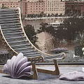 Wooden Slat Lounge Chair by Window with City Skyline View and Decorative Shell Ornament
