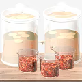 Clear Glass Spice Jars with Lids and Small Containers on Wooden Countertop