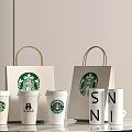 Starbucks Coffee Cups Display With Branded Paper Bags And White Tabletop Arrangement