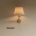 Modern Wall Lamp with Beige Fabric Shade and Gold Metal Base on Light Wall
