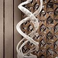 Intricate Silver Spiral Sculptural Art With Wooden Background And Triangular Cutouts