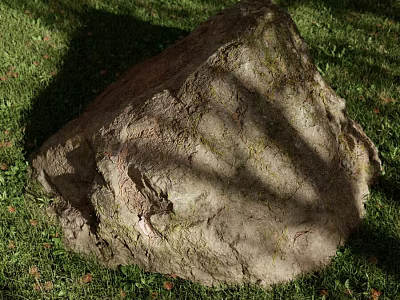 Large Textured Rock Resting on Lush Green Grass With Tree Shadows 3d model
