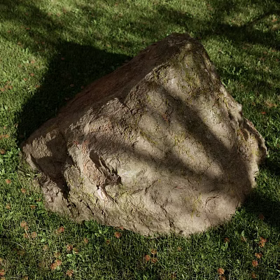 Large Textured Rock Resting on Lush Green Grass With Tree Shadows 3d model
