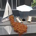Outdoor Terrace Floral Display With Sailboat Model Deck Chairs White Parasol And Green Tree