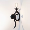 Black Spiral Design Wall Sconce with Transparent Lampshade and Soft Light Shadow on White Wall