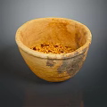 Hand Carved Clay Bowl Sculpture With Ancient Textured Surface And Seeds Inside