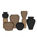 Black and Brown Ceramic Vessels in Various Shapes on Wooden Stands