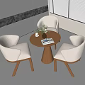 Minimalist Modern Round Wooden Table And Beige Chairs With Potted Plant And Magazine On Tabletop