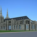 European Style Architecture With Gothic Spires Stone Facade Arched Windows Black Roof And Green Lawn