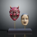Red Demon And Light Colored Human Face Costume Masks On Black Base With Golden Stands