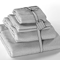 Luxury Stacked White Towels With Brown Stripes And Attached Decorative Tag
