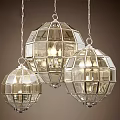 Three Modern Glass Globe Chandeliers with Metallic Grid Frame and Warm Lighting