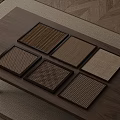 Square Coasters With Various Woven Textures Displayed On Wooden Tabletop