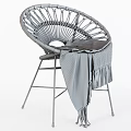 Round Wicker Rattan Chair With Knitted Blanket And Black Metal Legs