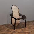 Modern Dining Chair With Woven Design And Dark Frame On Herringbone Wooden Floor