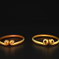 Golden Decorative Ornament Set Featuring Two Rings with Curled Designs