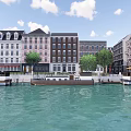 Waterfront Commercial Street With Colorful Historic Buildings Green Trees And Moored Boats