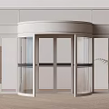 Modern Revolving Door Design With Glass Panels Light Colored Walls Floor And Potted Plant